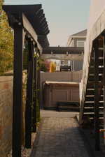 View of patio with a hot tub