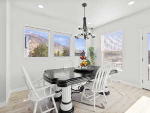 Dining area featuring an inviting chandelier and light hardwood / wood-style flooring