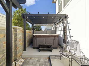 Wooden terrace with a pergola and a hot tub