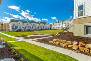 View of property's community featuring a lawn