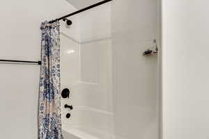 Bathroom featuring shower / bath combo with shower curtain