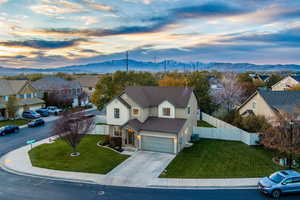 View of front of house with a mountain view, a yard, and a garage