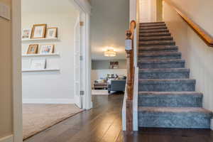 Stairway featuring hardwood / wood-style floors