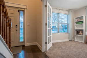 Entryway with dark wood-type flooring and a textured ceiling