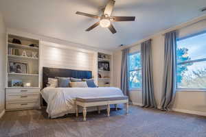 Carpeted bedroom with ceiling fan