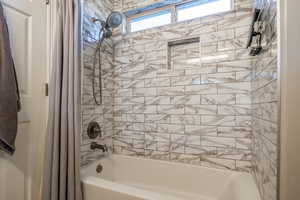 Bathroom featuring shower / tub combo with curtain