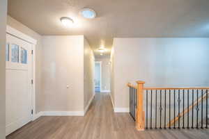 Foyer with wood-type flooring and a textured ceiling