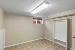 Basement with a textured ceiling