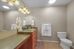 Bathroom with tile patterned floors, vanity, and toilet