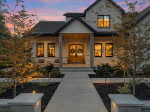 Exterior entry at dusk featuring a porch