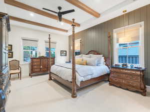 Carpeted bedroom with beam ceiling and ceiling fan