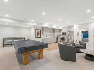 Recreation room with light wood-type flooring, sink, and pool table