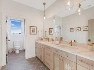 Bathroom featuring tile patterned floors, vanity, and toilet