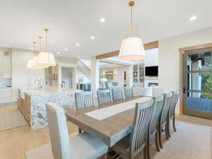 Dining room with light hardwood / wood-style floors and sink