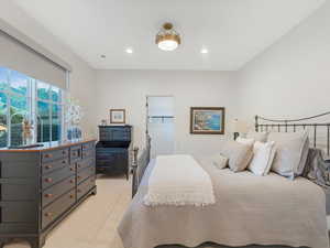 Carpeted bedroom featuring a walk in closet