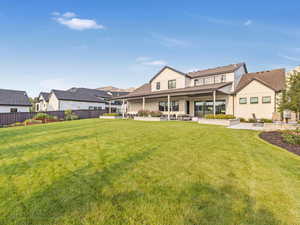 Back of house featuring a yard and a patio