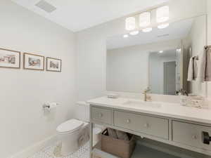 Bathroom featuring vanity and toilet