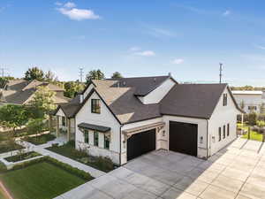 Modern farmhouse with a garage and a front lawn