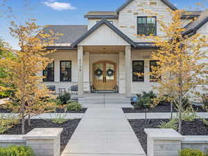 Entrance to property with a porch and cooling unit