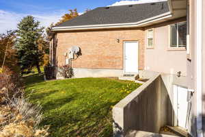 Back of house featuring a yard