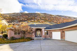 Single story home with a mountain view and a garage