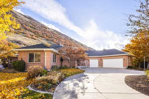 View of front facade featuring a mountain view and a garage