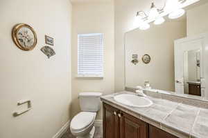 Bathroom with tile patterned flooring, vanity, and toilet