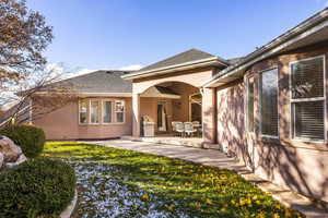 Back of house featuring a yard and a patio area