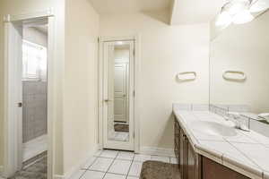 Bathroom with tile patterned floors and vanity