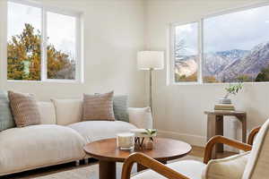 Sitting room with hardwood / wood-style flooring and a mountain view