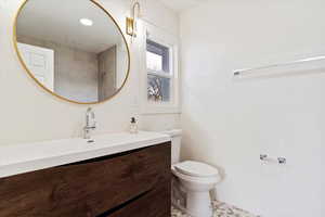 Bathroom with tile patterned flooring, vanity, and toilet