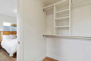 Spacious closet featuring hardwood / wood-style flooring