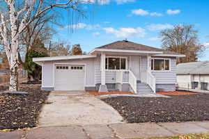 Bungalow featuring a garage