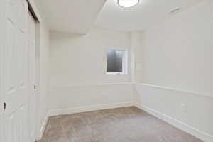 Empty room with light colored carpet