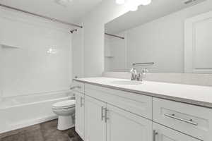 Full bathroom featuring shower / tub combination, vanity, and toilet