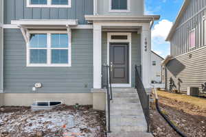 Property entrance featuring central AC unit