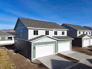 View of front of house featuring a mountain view and a garage