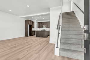 Stairway featuring hardwood / wood-style flooring and sink