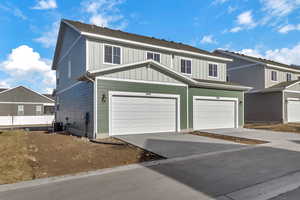 View of front of property with central AC and a garage