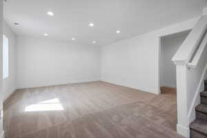 Unfurnished room featuring light carpet