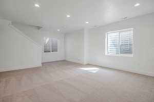 Unfurnished room featuring light colored carpet