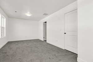 Unfurnished room with carpet floors