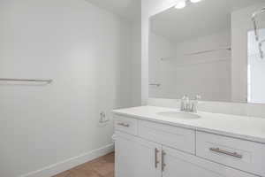 Bathroom with a shower, tile patterned floors, vanity, and toilet