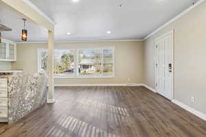 Interior space featuring dark hardwood / wood-style floors and ornamental molding