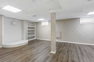 Basement featuring wooden walls and hardwood / wood-style flooring