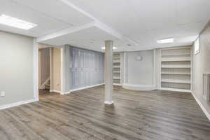 Basement with wood-type flooring