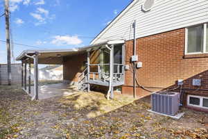 View of side of home with cooling unit