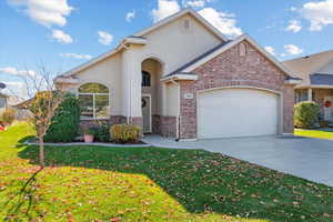 View of front facade featuring a garage and a front yard