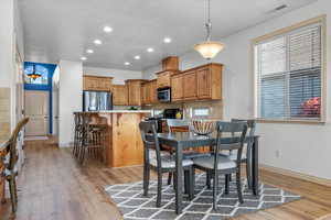 Dining space featuring light hardwood / wood-style floors and a textured ceiling