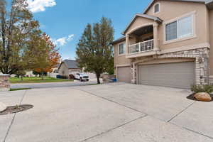 View of front of property with a garage and a balcony